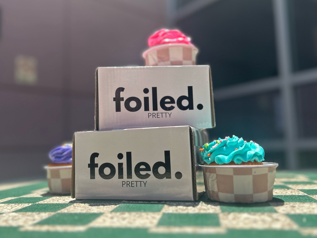 Creative product marketing example of students wrapping patterned Foiled Pretty hair foils around typical cupcake foils for enhanced cupcake decoration