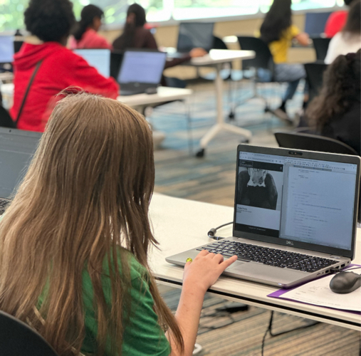 Girls Code Savannah Summer camp students reviewing UI/UX mobile responsiveness on their laptops during a frontend web development sprint